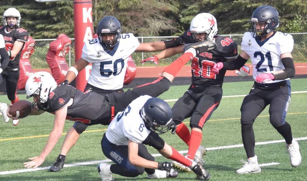 Homers Austin Briscoe tackles Kenai Centrals Zeke Yragui just short of the end zone Saturday, Sept. 2, 2023, at Ed Hollier Field at Kenai Central High School in Kenai, Alaska. (Photo by Jeff Helminiak/Peninsula Clarion)