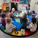 Christy Phillips reads to preschoolers at Seward Sprouts Preschool in Seward, Alaska. (Photo courtesy Seward Sprouts Preschool)