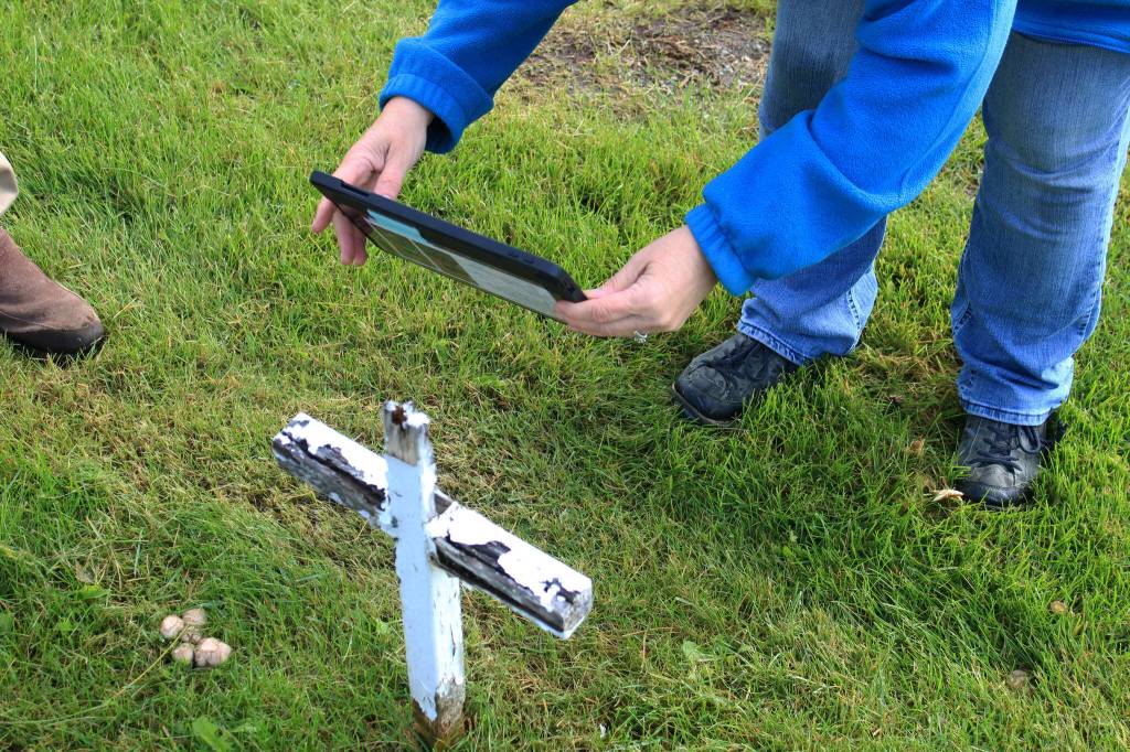Victoria Askin photographs a gravemarker in the Kenai Cemetery as part of a city imaging project on Friday, Sept. 8, 2023 in Kenai, Alaska. (Ashlyn OHara/Peninsula Clarion)