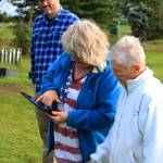 Victoria Askin (left) and Kenai Historical Society President June Harris (right) inspect an interactive map of the Kenai Cemetery as part of a city imaging project on Friday, Sept. 8, 2023, in Kenai, Alaska. (Ashlyn OHara/Peninsula Clarion)