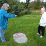 Victoria Askin (left) and Kenai Historical Society President June Harris (right) photograph headstones as part of the City of Kenais cemetery imaging project on Friday, Sept. 8, 2023, in Kenai, Alaska. (Ashlyn OHara/Peninsula Clarion)