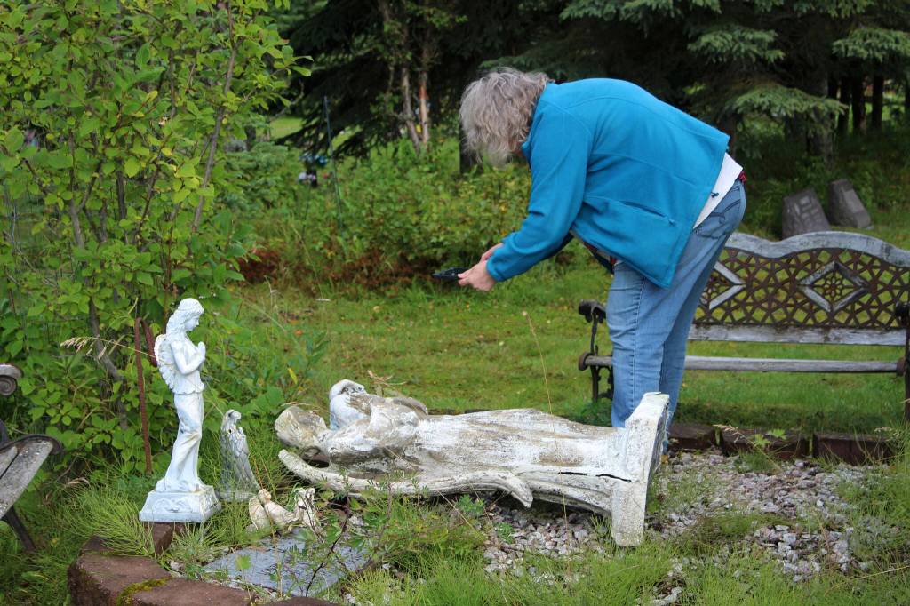 Victoria Askin photographs a headstone in the Kenai Cemetery as part of a city imaging project on Friday, Sept. 8, 2023, in Kenai, Alaska. (Ashlyn OHara/Peninsula Clarion)