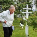 Kenai Historical Society President June Harris inspects a grave marker as part of the City of Kenais cemetery imaging project on Friday, Sept. 8, 2023, in Kenai, Alaska. (Ashlyn OHara/Peninsula Clarion)