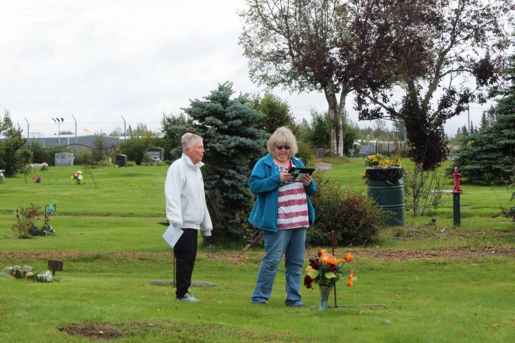 Kenai Historical Society President June Harris (left) and Victoria Askin (right) photograph headstones as part of the City of Kenais cemetery imaging project on Friday, Sept. 8, 2023, in Kenai, Alaska. (Ashlyn OHara/Peninsula Clarion)