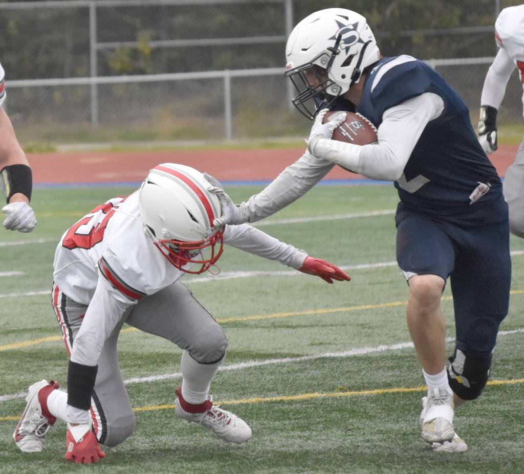 Soldotnas Leigh Tacey tries to avoid Wasillas Kemeul Rodriguez on Friday, Sept. 8, 2023, at Justin Maile Field at Soldotna High School in Soldotna, Alaska. (Photo by Jeff Helminiak/Peninsula Clarion)