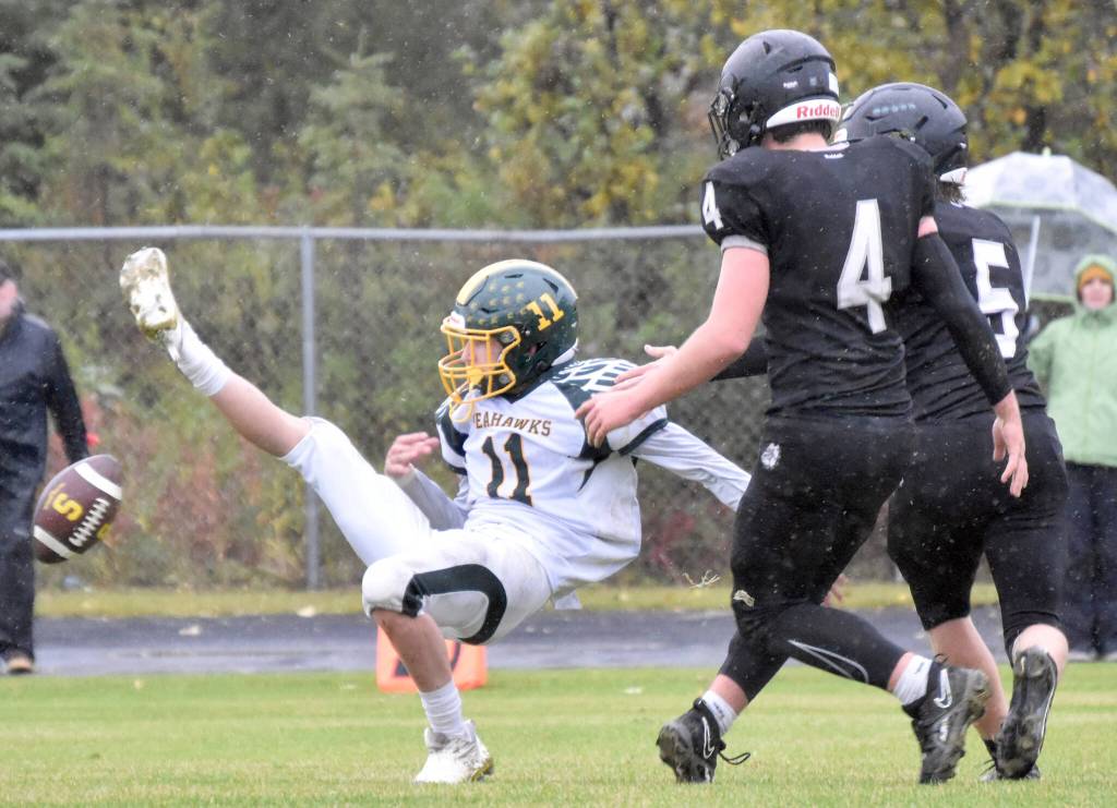 Nikiskis Oliver Parrish and Everett Chamberlain break up a pass intended for Sewards Hunter Forshee-Kurtz on Saturday, Sept. 16, 2023, at Nikiski Middle-High School in Nikiski, Alaska. (Photo by Jeff Helminiak/Peninsula Clarion)