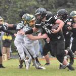 Nikiskis Truit McCaughey tries to break the tackle of Sewards Judah Brueckner on Saturday, Sept. 16, 2023, at Nikiski Middle-High School in Nikiski, Alaska. (Photo by Jeff Helminiak/Peninsula Clarion)