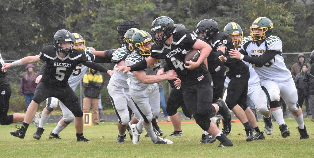 Nikiskis Truit McCaughey tries to break the tackle of Sewards Judah Brueckner on Saturday, Sept. 16, 2023, at Nikiski Middle-High School in Nikiski, Alaska. (Photo by Jeff Helminiak/Peninsula Clarion)