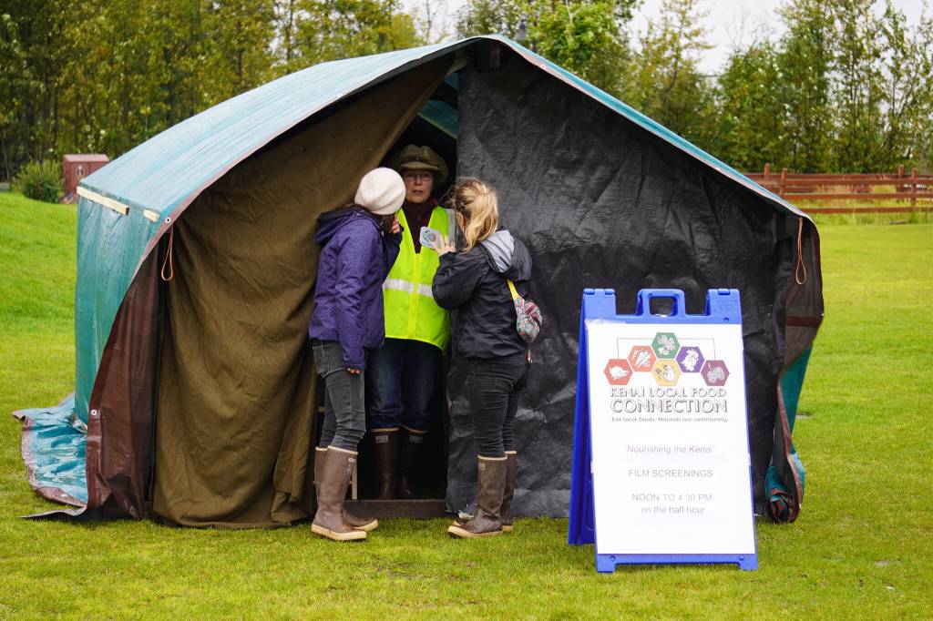 A tent hosts screenings of Nourishing the Kenai during the Harvest Moon Local Food Festival at Soldotna Creek Park in Soldotna, Alaska, on Saturday, Sept. 16, 2023. (Jake Dye/Peninsula Clarion)