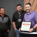 Skyview Middle School teacher Patrick Herding receives a certificate naming him the Alaska teacher representative for the Victra + Ron Clark Academy Professional Development Experience at the grand opening of Victra in Soldotna, Alaska, on Friday, Sept. 15, 2023. (Jake Dye/Peninsula Clarion)