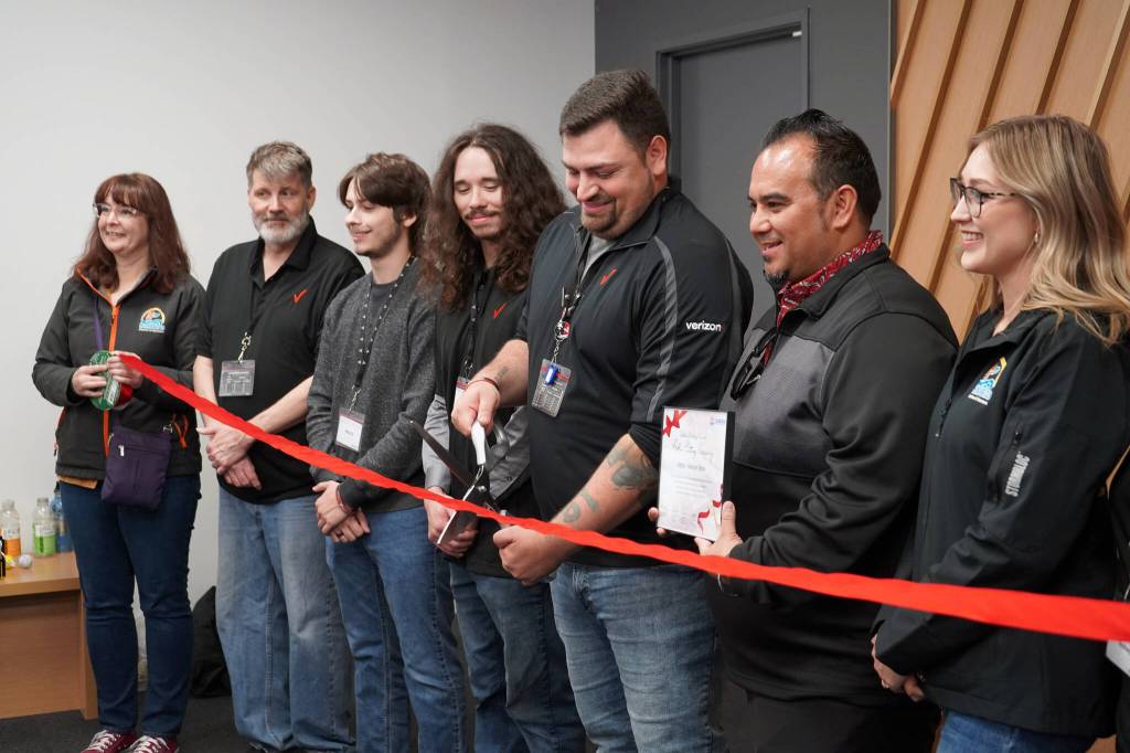 Andrew Farina prepares to cut the ribbon at the grand opening of Victra in Soldotna, Alaska, on Friday, Sept. 15, 2023. (Jake Dye/Peninsula Clarion)
