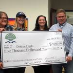 Dolores Roddis, adult winner of the Seventh Annual Kenai Silver Salmon Derby, is presented a novelty check by Kenai River Sportfishing Association Executive Director Shannon Martin, Kenai Chamber of Commerce Executive Director Samantha Springer, and City of Kenai Mayor Brian Gabriel at the Kenai Chamber of Commerce and Visitor Center in Kenai, Alaska, on Wednesday, Sept. 20, 2023. (Jake Dye/Peninsula Clarion)