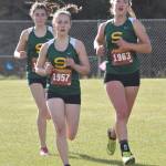 Selah Brueckner (1957), Katie Van Buskirk (1963) and Maddie Haas compete in the Kenai Peninsula Borough girls varsity race Thursday, Sept. 21, 2023, at Tsalteshi Trails just outside of Soldotna, Alaska. (Photo by Jeff Helminiak/Peninsula Clarion)