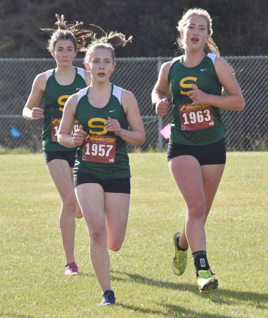 Selah Brueckner (1957), Katie Van Buskirk (1963) and Maddie Haas compete in the Kenai Peninsula Borough girls varsity race Thursday, Sept. 21, 2023, at Tsalteshi Trails just outside of Soldotna, Alaska. (Photo by Jeff Helminiak/Peninsula Clarion)