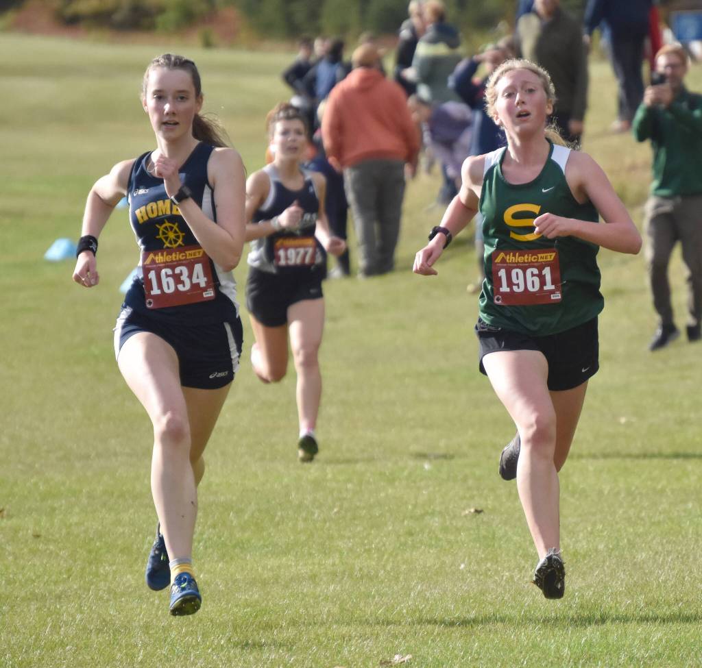 Homers Beatrix McDonough and Sewards Juniper Ingalls sprint to the finish of the Kenai Peninsula Borough girls varsity race Thursday, Sept. 21, 2023, at Tsalteshi Trails just outside of Soldotna, Alaska. (Photo by Jeff Helminiak/Peninsula Clarion)