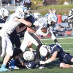 The Soldotna defense teams up to bring down Chugiaks Tyson Billman on Friday, Sept. 22, 2023, at Justin Maile Field at Soldotna High School in Soldotna, Alaska. (Photo by Jeff Helminiak/Peninsula Clarion)