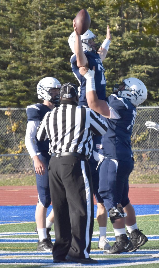 Soldotnas Hokoa Montoya hoists up Gehret Medcoff after a touchdown against Chugiak on Friday, Sept. 22, 2023, at Justin Maile Field at Soldotna High School in Soldotna, Alaska. (Photo by Jeff Helminiak/Peninsula Clarion)