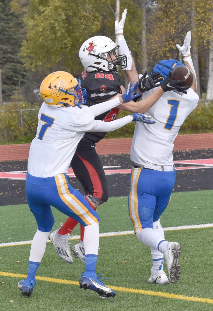Barrows Eric Librado and Angelo Reyes break up a pass intended for Kenai Centrals Sawyer Vann on Saturday, Sept. 23, 2023, at Ed Hollier Field at Kenai Central High School in Kenai, Alaska. (Photo by Jeff Helminiak/Peninsula Clarion)