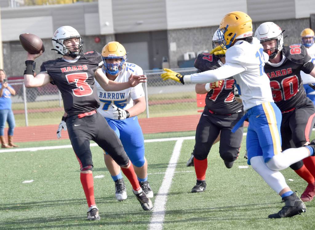 Kenai Centrals Zeke Yragui throws under pressure from Barrows Uatahouse Tuifua and Alex Fruean on Saturday, Sept. 23, 2023, at Ed Hollier Field at Kenai Central High School in Kenai, Alaska. (Photo by Jeff Helminiak/Peninsula Clarion)