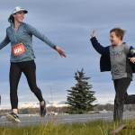 Amy Anderson gets encouragement from her son, Everett, in the marathon relay at the Kenai River Marathon on Sunday, Sept. 24, 2023, in Kenai, Alaska. Anderson teamed with Bethany Nyboer, Katy Coseglia and Chelsea Wingard to finish fourth with Soar B.A.C.K.s. (Photo by Jeff Helminiak/Peninsula Clarion)