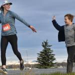 Amy Anderson gets encouragement from her son, Everett, in the marathon relay at the Kenai River Marathon on Sunday, Sept. 24, 2023, in Kenai, Alaska. Anderson teamed with Bethany Nyboer, Katy Coseglia and Chelsea Wingard to finish fourth with Soar B.A.C.K.'s. (Photo by Jeff Helminiak/Peninsula Clarion)