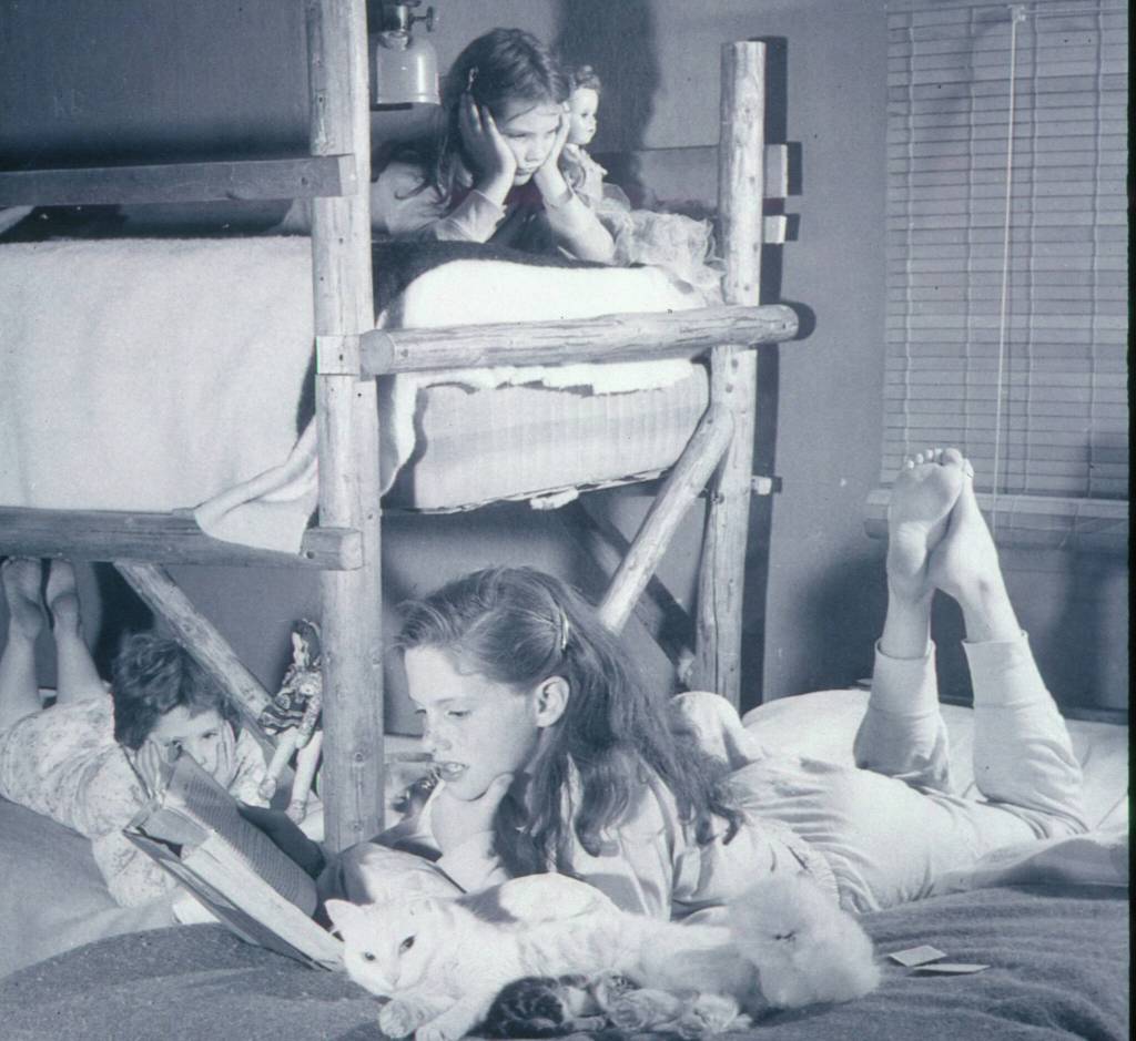 1954 photo by Bob and Ira Spring for Better Homes & Garden magazine
Eldest daughter Martha (foreground) reads to her sisters Lori (top bunk) and Abby.