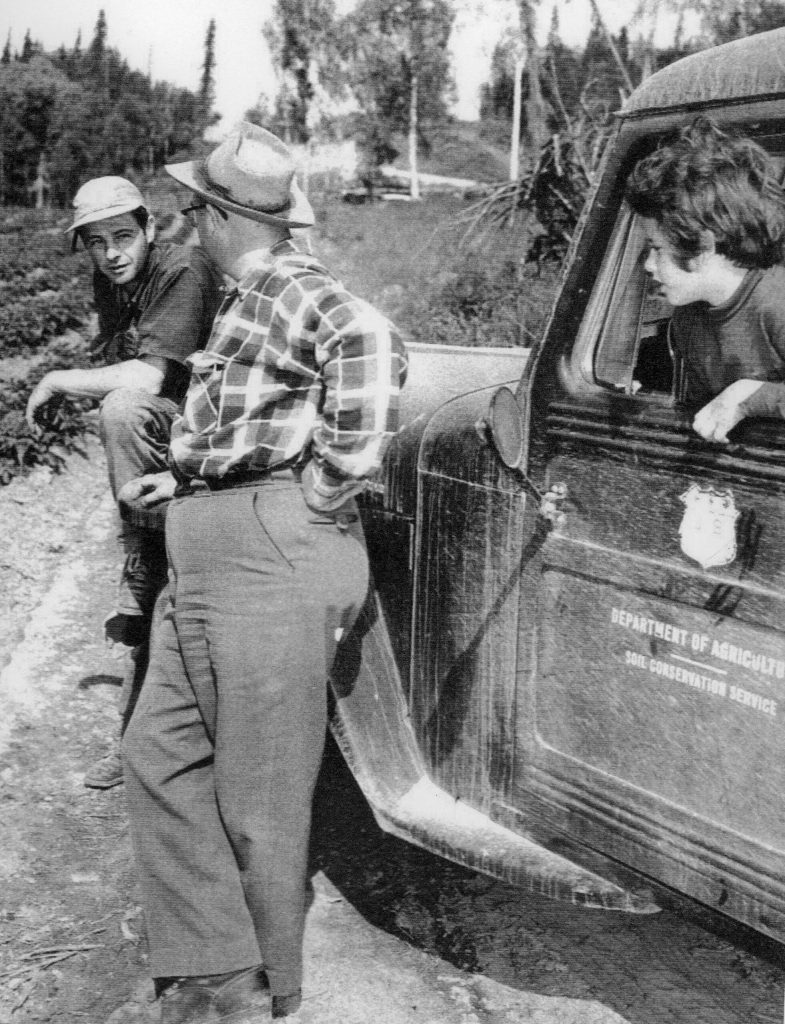 1954 photo by Bob and Ira Spring for Better Homes & Garden magazine
Larry Lancashire (far left) chats with a representative from the Department of Agricultures Soil Conservation Service, as daughter Abby listens in.