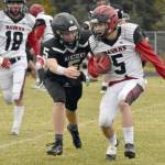 Eielsons Alexander Miranda is tackled by Nikiskis Everett Chamberlain on Saturday, Sept. 30, 2023, at Nikiski Middle-High School in Nikiski, Alaska. (Photo by Jeff Helminiak/Peninsula Clarion)