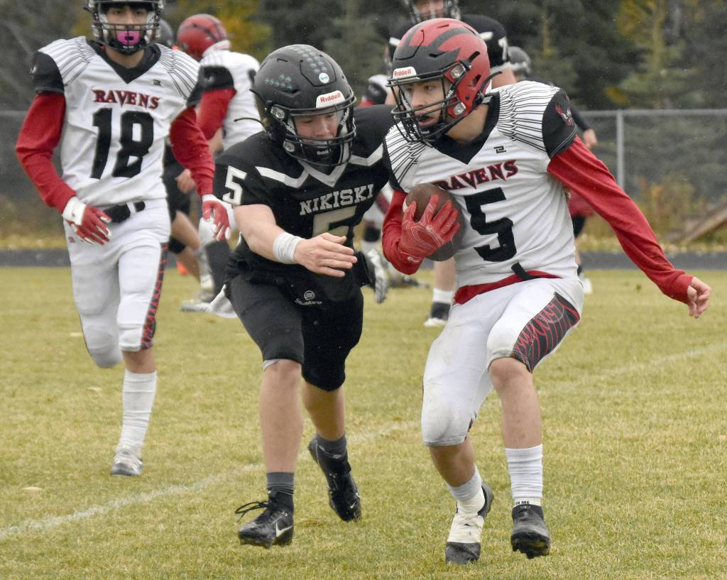 Eielsons Alexander Miranda is tackled by Nikiskis Everett Chamberlain on Saturday, Sept. 30, 2023, at Nikiski Middle-High School in Nikiski, Alaska. (Photo by Jeff Helminiak/Peninsula Clarion)