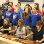 Aurora Borealis Charter School Art and Music Teacher Eleanor Van Sickle leads students in a performance of "Autumn Canon," a Hungarian song at a meeting of the Kenai Peninsula Borough School District Board of Education meeting on Monday, Oct. 2, 2023 in Soldotna, Alaska. (Ashlyn O'Hara/Peninsula Clarion)