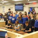 Aurora Borealis Charter School Art and Music Teacher Eleanor Van Sickle leads students in a performance of "Autumn Canon," a Hungarian song at a meeting of the Kenai Peninsula Borough School District Board of Education meeting on Monday, Oct. 2, 2023 in Soldotna, Alaska. (Ashlyn O'Hara/Peninsula Clarion)