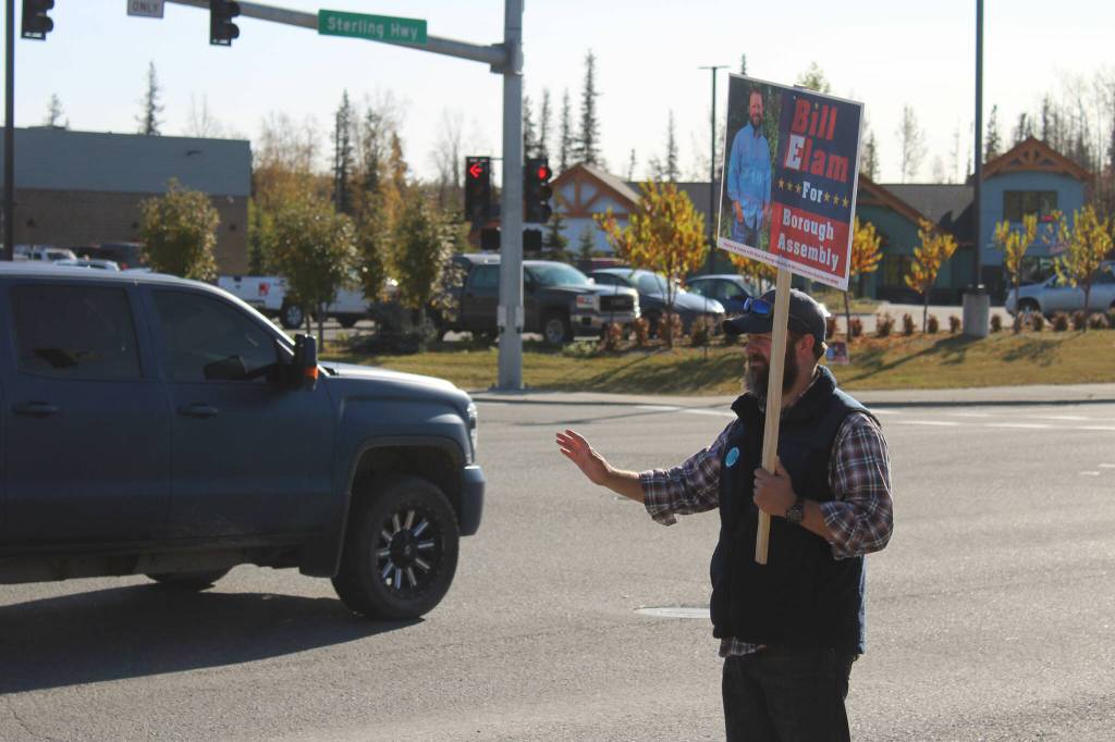 Kenai Peninsula Borough Assembly Candidate Bill Elam waves signs on election day on Tuesday, Oct 3, 2023, in Soldotna, Alaska. (Ashlyn OHara/Peninsula Clarion)
