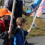 James Elam, left, and Andrew Elam, right, wave signs for their dad, Kenai Peninsula Borough Assembly candidate Bill Elam, on election day on Tuesday, Oct. 3, 2023, in Soldotna, Alaska. (Ashlyn OHara/Peninsula Clarion)