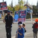 From left: Kenai Peninsula Borough Assembly candidate Bill Elam waves signs with his sons, William, Andrew and James on election day on Tuesday, Oct. 3, 2023, in Soldotna, Alaska. (Ashlyn OHara/Peninsula Clarion)