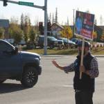 Kenai Peninsula Borough Assembly Candidate Bill Elam waves signs on election day on Tuesday, Oct 3, 2023, in Soldotna, Alaska. (Ashlyn OHara/Peninsula Clarion)