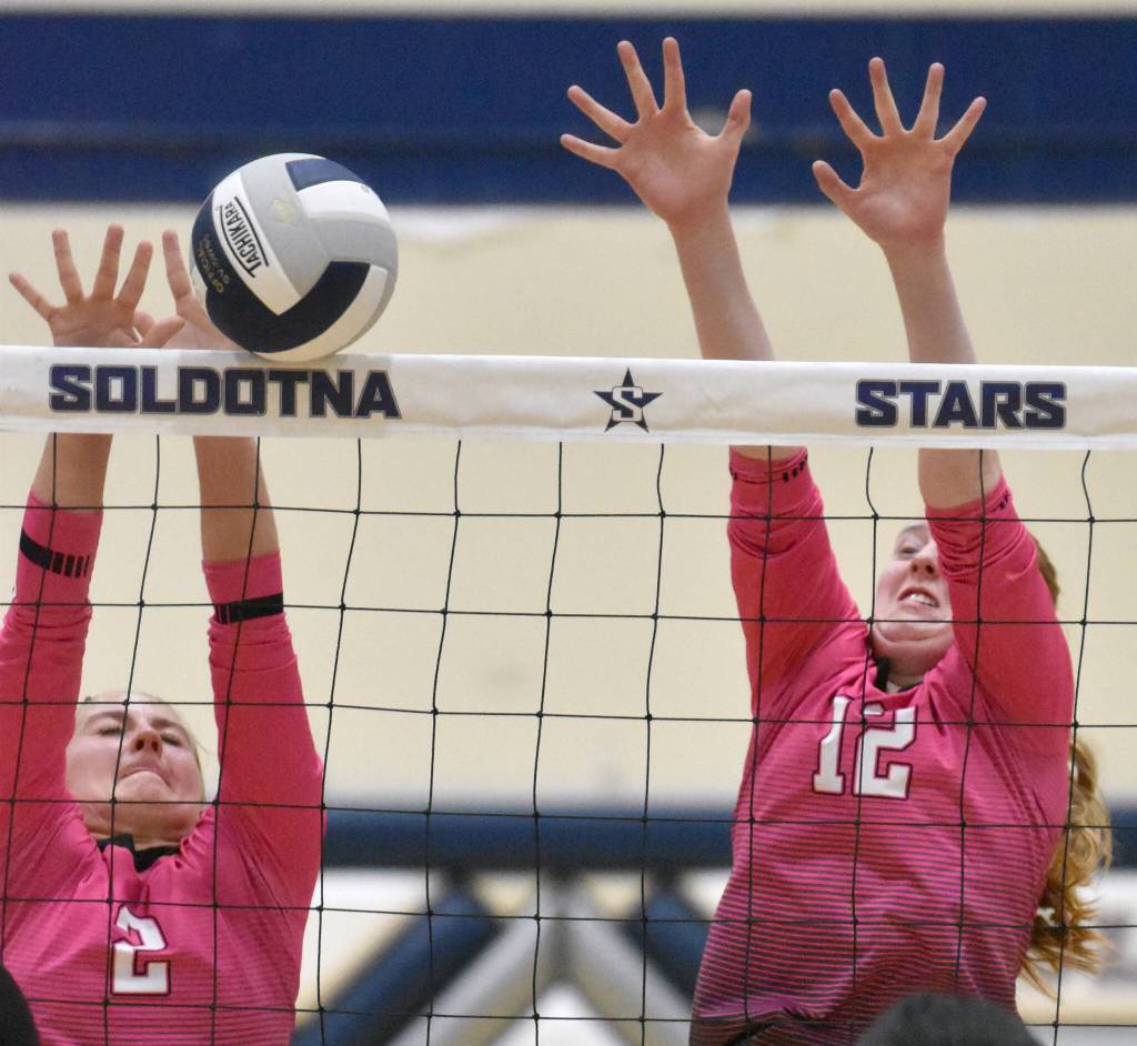 Kenai Centrals Kate Wisnewski and Ellsi Miller put up a block against Soldotna on Tuesday, Oct. 3, 2023, at Soldotna High School in Soldotna, Alaska. (Photo by Jeff Helminiak/Peninsula Clarion)