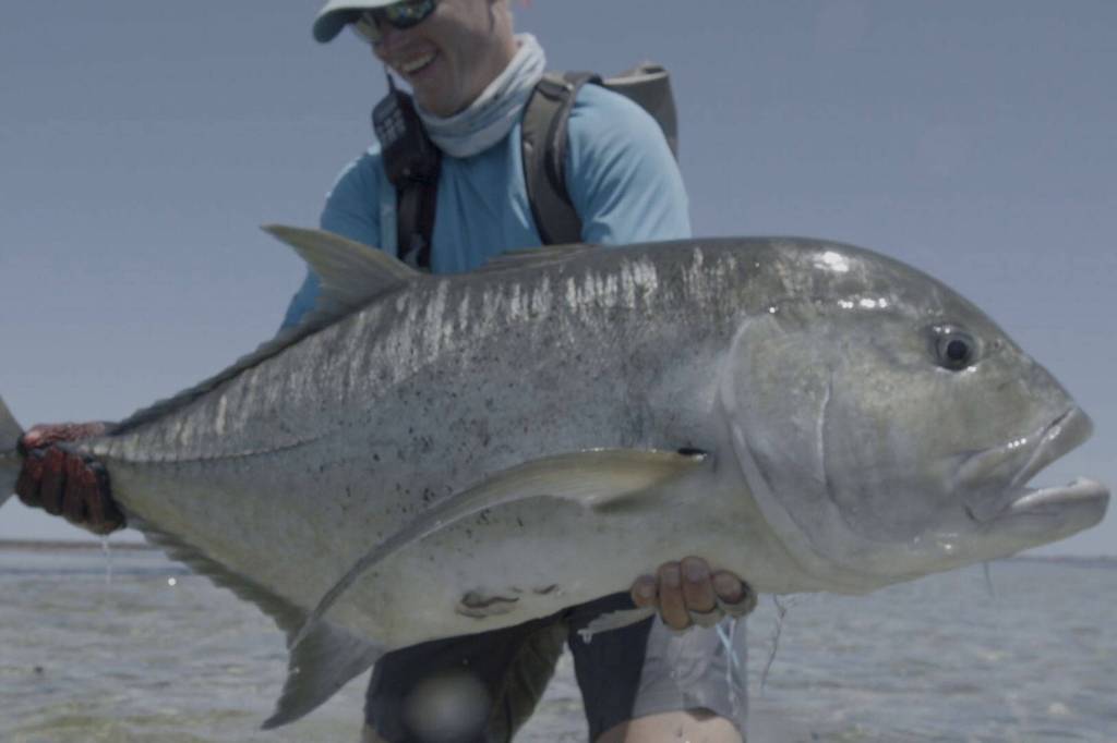 An angler holds up a massive fish in Jacks: A Film by Jako Lucas & Ra Beattie. (Photo courtesy International Fly Fishing Festival)