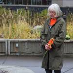 Mary Hunt, a survivor of Holy Cross Mission, holds flowers during an Orange Shirt Day ceremony at Ggugguyni T'uh, "Raven Place," outside the Dena'ina Wellness Center on Friday, Oct. 6, 2023 in Kenai, Alaska. Orange Shirt Day honors indigenous elders who survived and children lost from boarding schools established to detribalize indigenous people. (Ashlyn O'Hara/Peninsula Clarion)