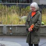 Mary Hunt, a survivor of Holy Cross Mission, holds flowers during an Orange Shirt Day ceremony at Ggugguyni Tuh, Raven Place, outside the Denaina Wellness Center on Oct. 6 in Kenai. (Ashlyn OHara/Peninsula Clarion)