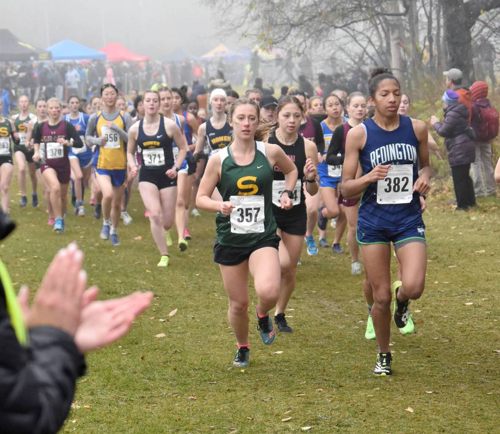 Sewards Hailey Ingalls leads Kenai Centrals Emilee Wilson off the start Saturday, Oct. 7, 2023, in the Division II girls state cross-country race at Palmer High School in Palmer, Alaska. (Photo by Jeff Helminiak/Peninsula Clarion)