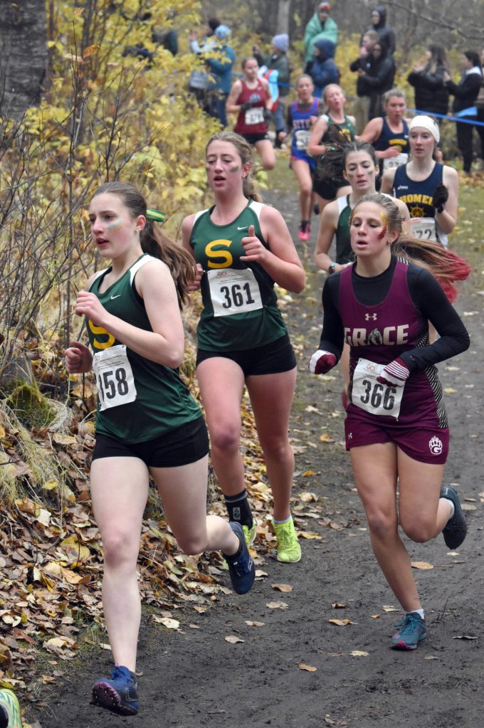Sewards Selah Brueckner and Kate Van Buskirk lead a pack of runners Saturday, Oct. 7, 2023, at the Division II girls state cross-country meet at Palmer High School in Palmer, Alaska. (Photo by Jeff Helminiak/Peninsula Clarion)