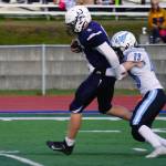 Soldotnas Andrew Pieh moves with the ball while Chugiaks Landen Fell tries to drag him down during a Division II playoff game at Justin Maile Field in Soldotna, Alaska, on Saturday, Oct. 7, 2023. (Jake Dye/Peninsula Clarion)