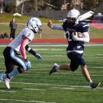 Soldotnas Wyatt Faircloth runs with the ball while fending off Chugiaks Luke Poland during a Division II playoff game at Justin Maile Field in Soldotna, Alaska, on Saturday, Oct. 7, 2023. (Jake Dye/Peninsula Clarion)