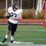 Homers Jake Tappan runs with the ball during a Division III playoff game at Justin Maile Field in Soldotna, Alaska, on Saturday, Oct. 7, 2023. (Jake Dye/Peninsula Clarion)