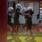 The Kenai Central Kardinals celebrate a game winning touchdown scored by Bobby Hayes during a Division III playoff game at Ed Hollier Field in Kenai, Alaska, on Saturday, Oct. 7, 2023. (Jake Dye/Peninsula Clarion)