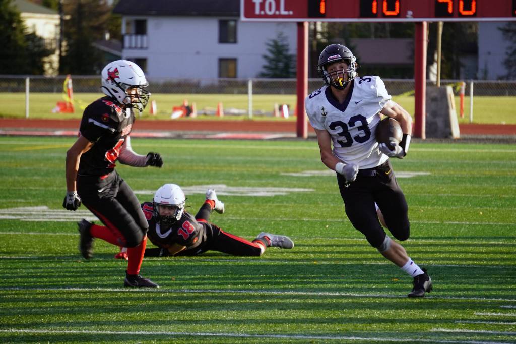 Homers Jake Tappan runs with the ball during a Division III playoff game at Justin Maile Field in Soldotna, Alaska, on Saturday, Oct. 7, 2023. (Jake Dye/Peninsula Clarion)