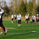 Homers CJ Burns and Kenais Cole Langham leap for the ball during a Division III playoff game at Justin Maile Field in Soldotna, Alaska, on Saturday, Oct. 7, 2023. (Jake Dye/Peninsula Clarion)
