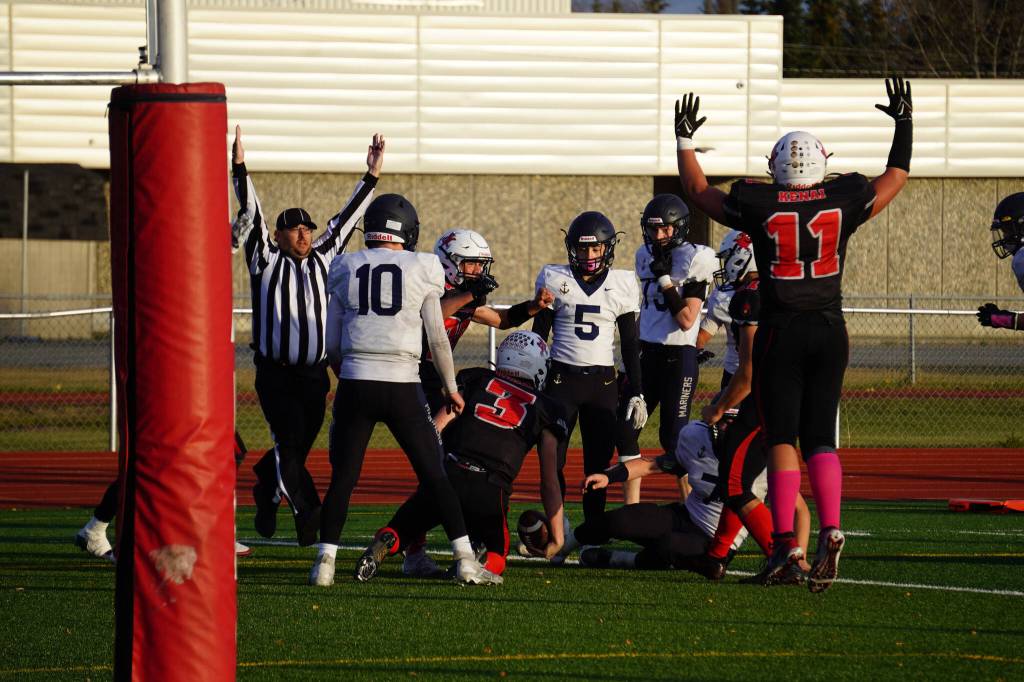 Kenais Zeke Yragui rises after scoring a touchdown with less than a minute left during a Division III playoff game at Justin Maile Field in Soldotna, Alaska, on Saturday, Oct. 7, 2023. (Jake Dye/Peninsula Clarion)