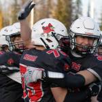 Kenais Spencer Maw is embraced by Logan Myers after recovering an onside kick to keep the Kardinals in the game with less than a minute on the clock during a Division III playoff game at Justin Maile Field in Soldotna, Alaska, on Saturday, Oct. 7, 2023. (Jake Dye/Peninsula Clarion)
