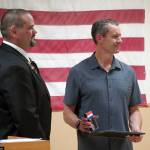 Kenai Elks Lodge Exalted Ruler Allen Burkett presents Kenai Fire Marshal Jeremy Hamilton with an award at the Kenai Elks Lodge in Kenai, Alaska, on Friday, Oct. 6, 2023. (Jake Dye/Peninsula Clarion)